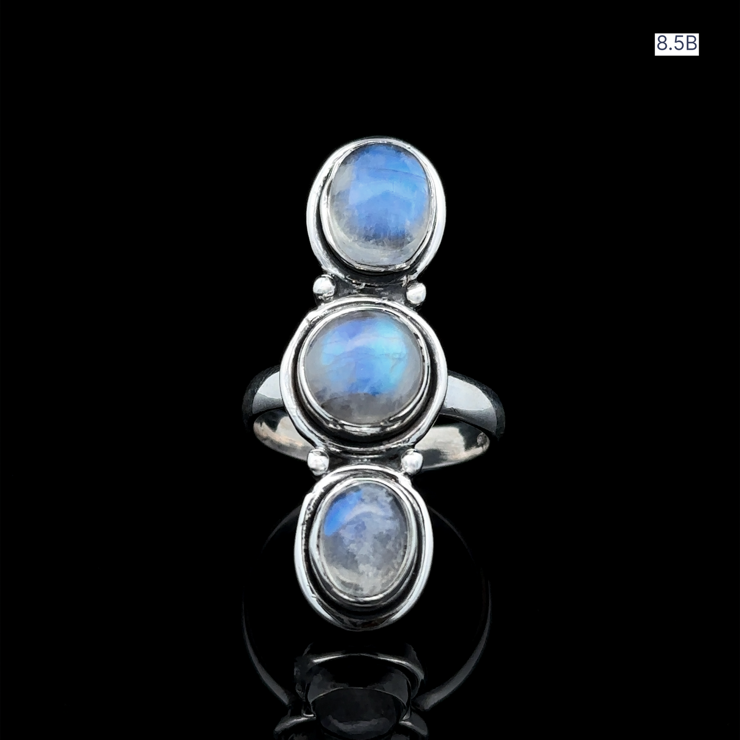 
                  
                    The Triple Moonstone Ring is crafted from sterling silver and features three vertically aligned oval moonstones set against a black backdrop, radiating goddess energy.
                  
                