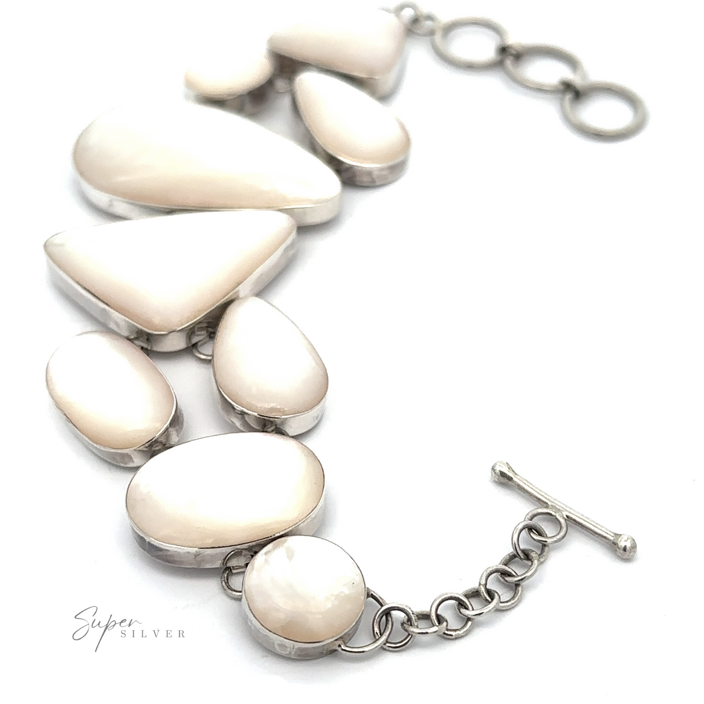 A Statement Mother of Pearl Bracelet crafted from sterling silver, featuring seven white Mother-of-Pearl stones of varying shapes linked by a delicate chain and a toggle clasp.