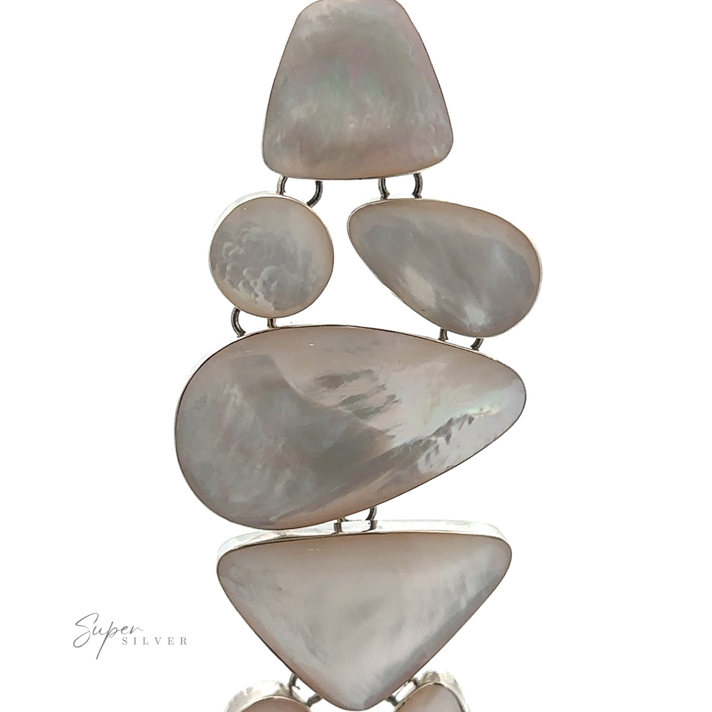 
                  
                    An assortment of polished, irregularly-shaped white stones set in silver are linked together vertically, creating a stunning Statement Mother of Pearl Bracelet. The image has a "Super Silver" watermark in the lower left corner.
                  
                