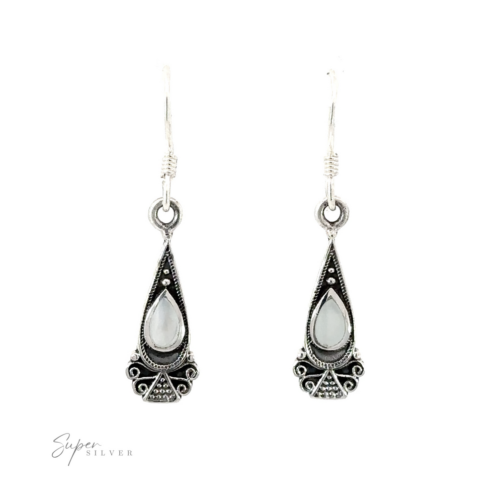 
                  
                    Bali Inspired Teardrop Shaped Earrings With Inlay Stones with a Bali-inspired design and inlaid white stones.
                  
                