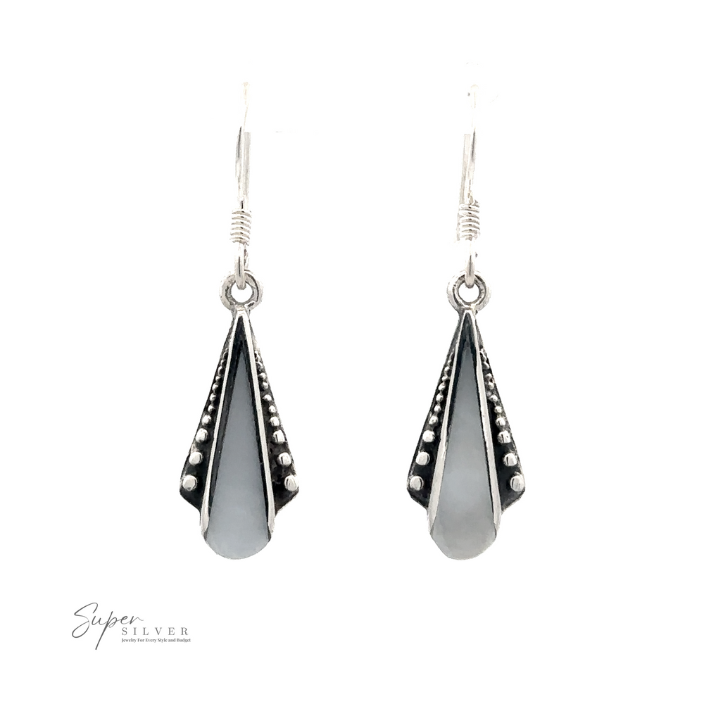 
                  
                    A pair of Inlaid Teardrop Shaped Bali Inspired Earrings with a beaded edge, featuring a touch of Mother of Pearl and hook fastening.
                  
                