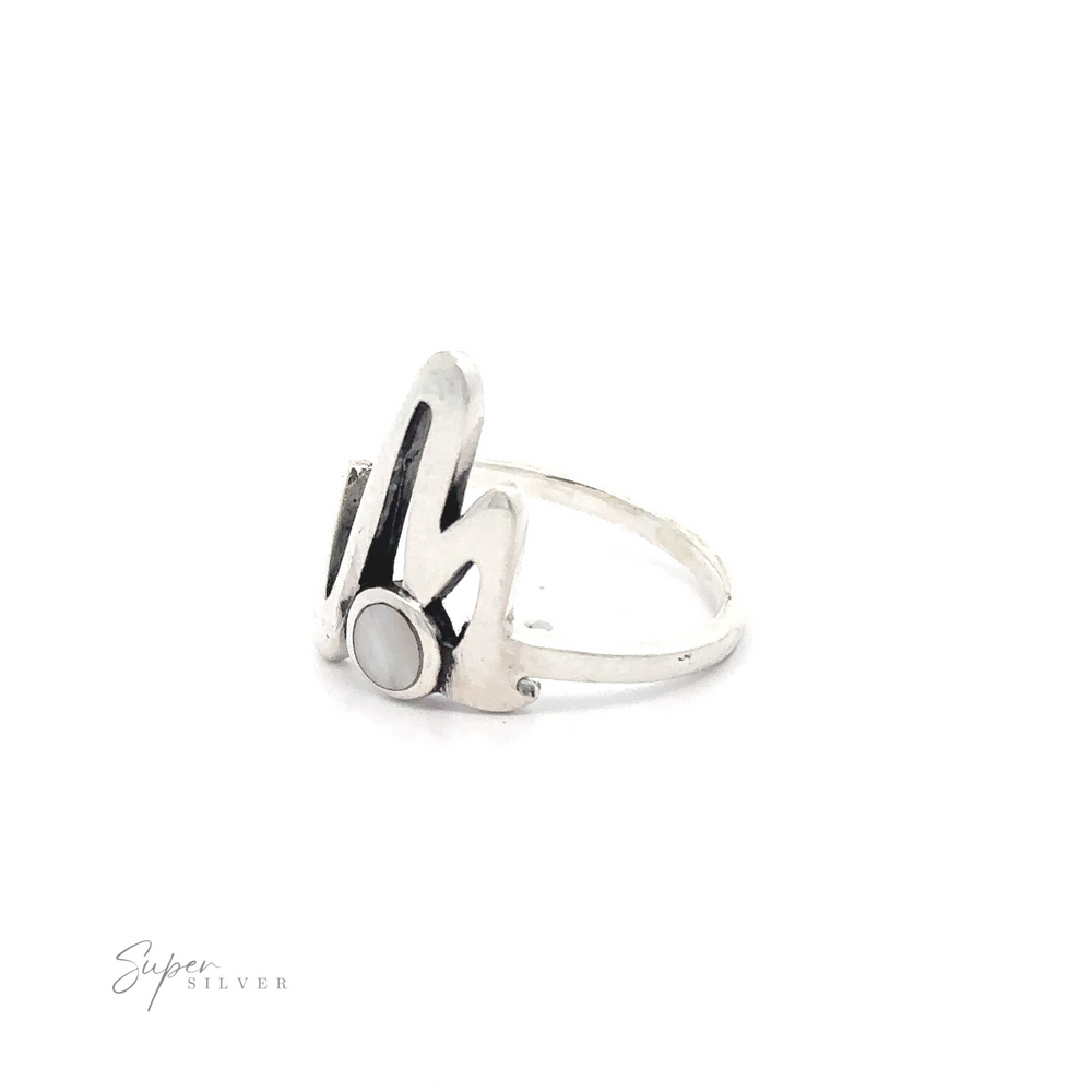 
                  
                    Stone Inlay Zig Zag ring with a sleek, modern design featuring a black onyx and white enamel detail on a white background.
                  
                