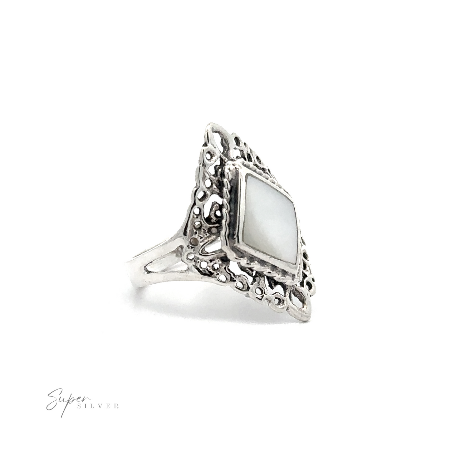 
                  
                    A diamond-shaped filigree mother of pearl ring with inlaid stones on a white background.
                  
                
