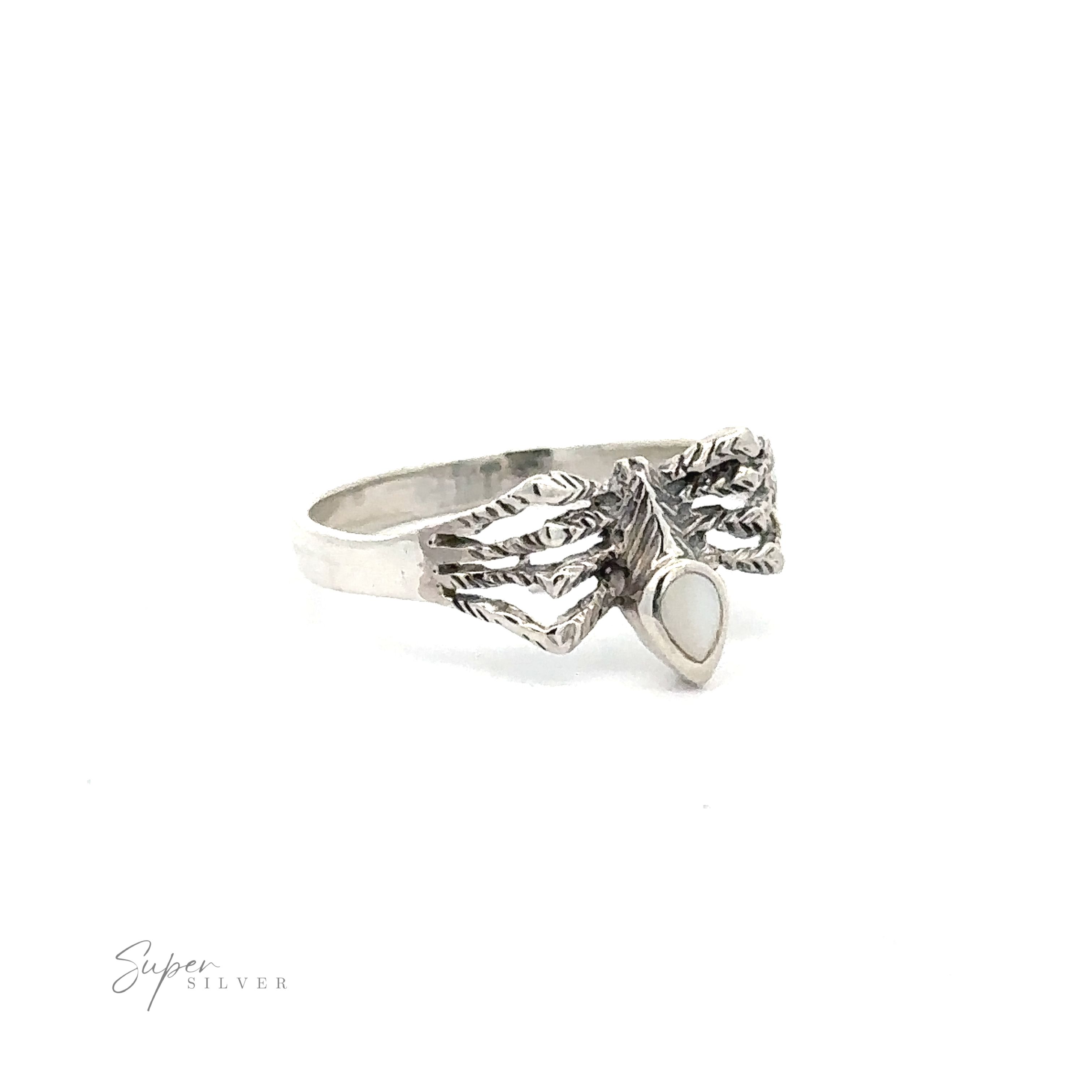 A Small Inlay Spider Ring featuring an intricate leaf design with a small, white oval centerpiece gemstone, exuding the charm of mystical jewelry.