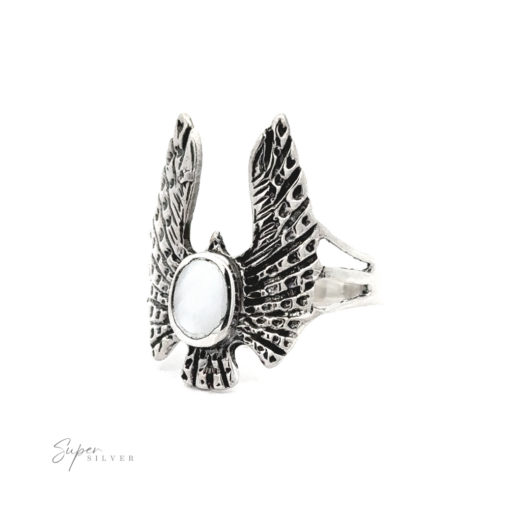 
                  
                    Inlaid Stone Ring with Eagle Wings crafted in a bohemian fashion to resemble a pair of eagle wings with a central circular gemstone, displayed against a white background.
                  
                