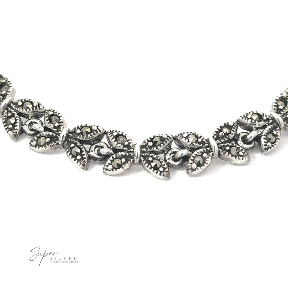 
                  
                    Close-up of a silver necklace intricately designed with connected leaf-shaped links, reminiscent of the Art Deco era. The "Marcasite Butterfly Bracelet" logo is visible in the bottom left corner, adding to its charm. This piece pairs beautifully with our Marcasite Butterfly Bracelet for a complete look.
                  
                