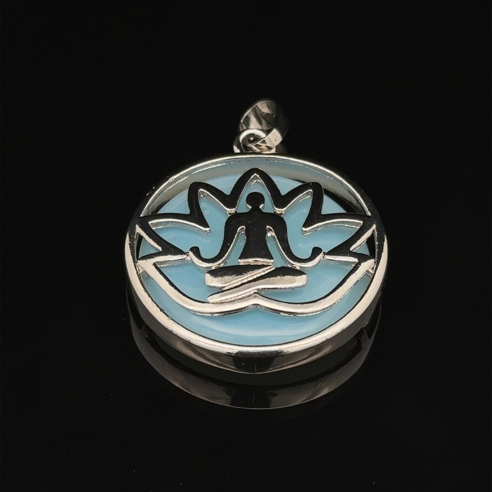 
                  
                    A Silver Plated Lotus Meditation Pendant with Gemstone featuring a person in a meditative pose, set against a blue background with intricate lotus flower petals.
                  
                