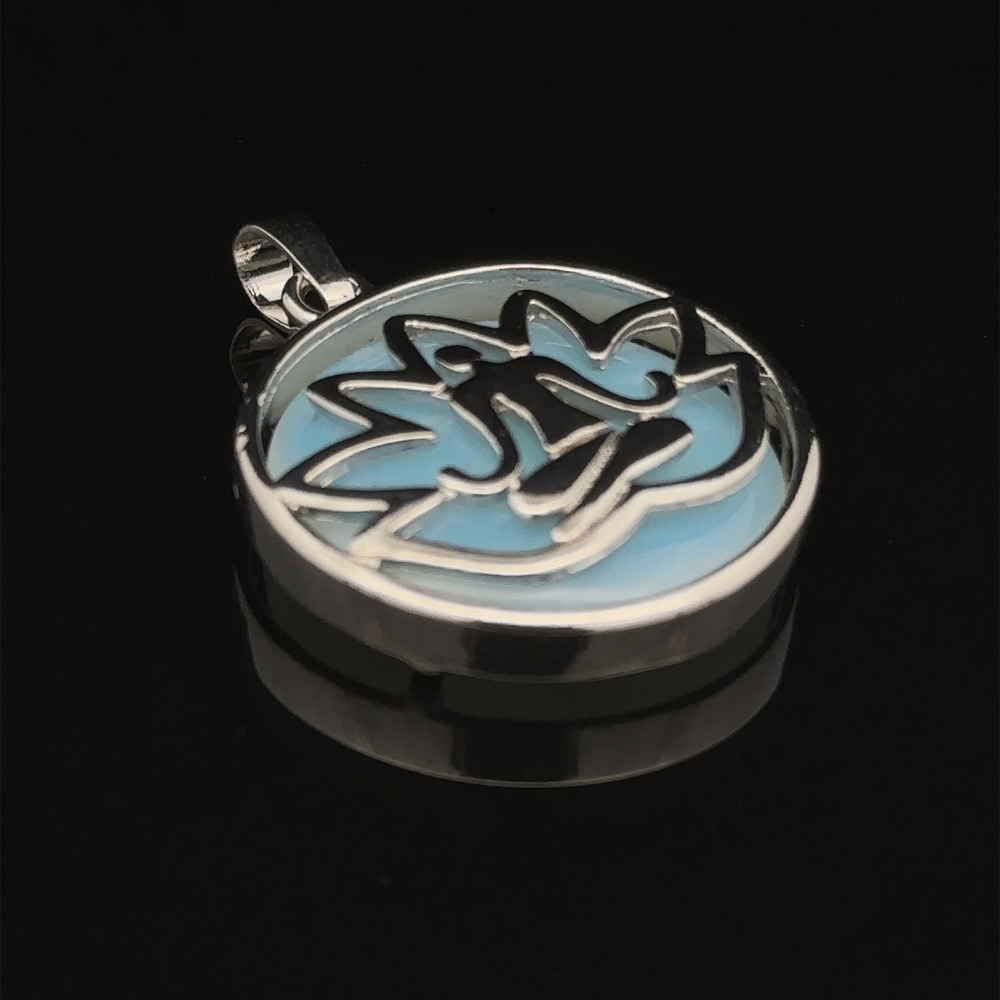 
                  
                    A Silver Plated Lotus Meditation Pendant with Gemstone featuring a stylized lotus design with blue enamel details and a striking black background.
                  
                