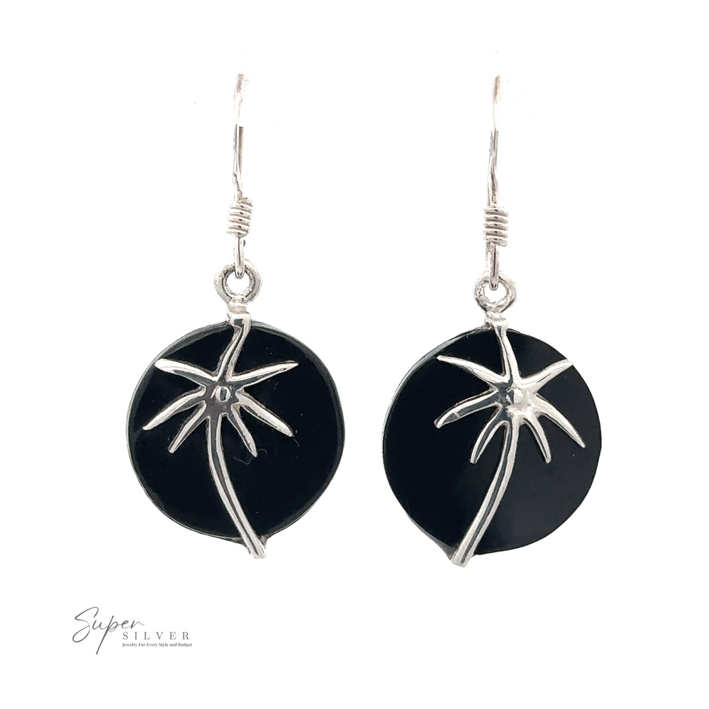 
                  
                    Two Stone Earrings with Silver Palm Tree featuring silver palm tree designs, hanging from simple hooks. A small logo in the corner reads "Super Silver.
                  
                