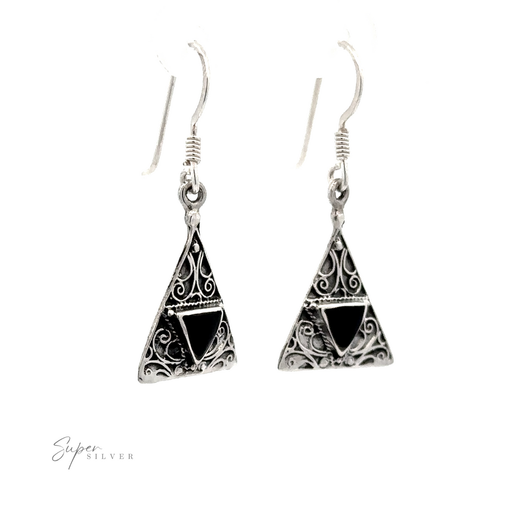 
                  
                    Freestyle Design Triangle Shape Inlaid Earrings with intricate filigree designs and black inlays, hanging from hook wires.
                  
                
