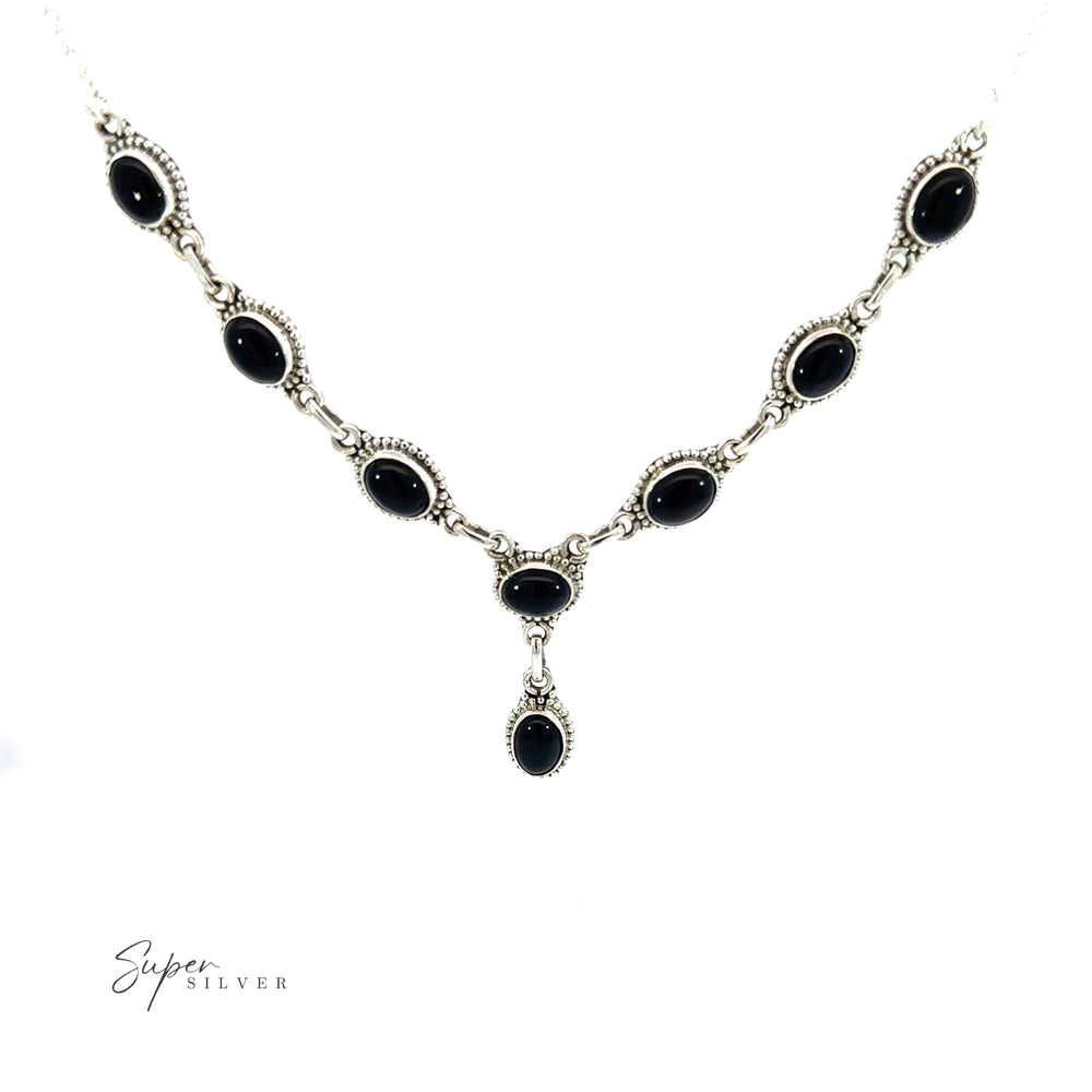 
                  
                    The Gemstone Y-Necklaces with Beaded Border feature a black onyx pendant on a delicate white background. Each gemstone in these necklaces is carefully selected for its vibrant color and natural beauty, ensuring that it
                  
                