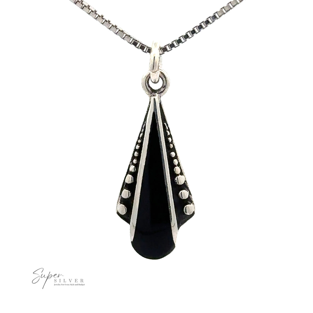 
                  
                    A Teardrop Pendant with Inlaid Stones and Ball Border featuring a black gemstone, adorned with small silver dots along its edges.
                  
                