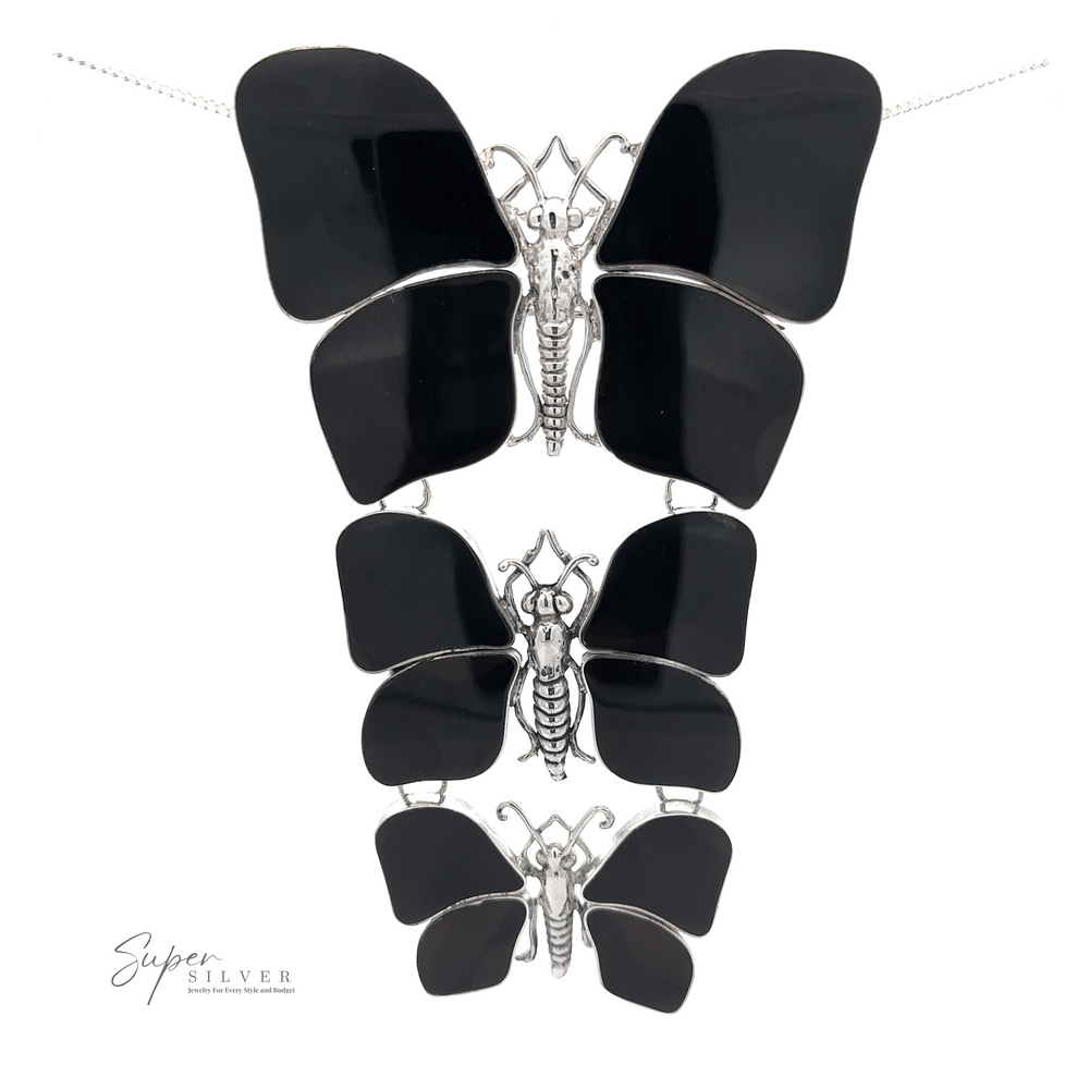
                  
                    A Statement Pendant or Brooch with Three Butterflies of varying sizes arranged vertically. Perfect for the nature lover, the brand name "Super Silver" is visible in the bottom left corner.
                  
                