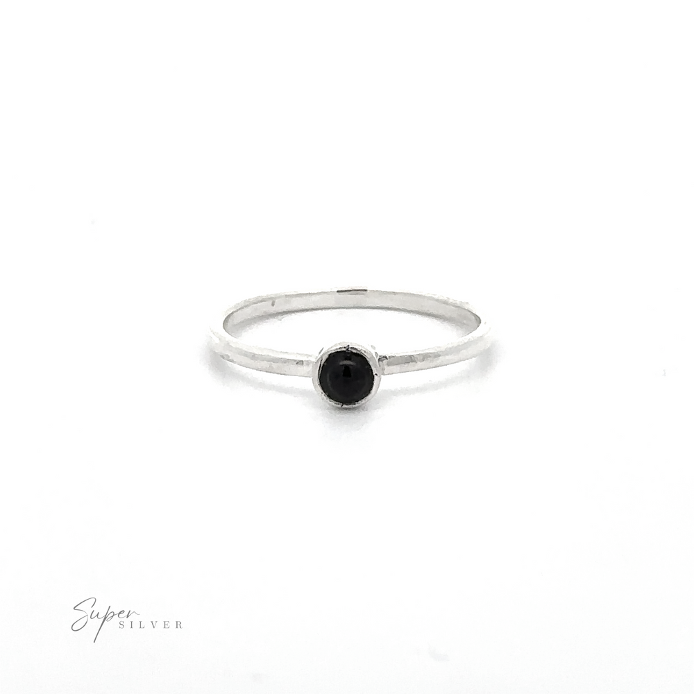 
                  
                    A simple silver ring featuring a small, round black gemstone in its center, perfect for minimalist fashion. The thin band adds to its elegant simplicity. Made of sterling silver, this Dainty Stackable Round Gemstone Ring has "Super Silver" visible in the bottom left corner.
                  
                