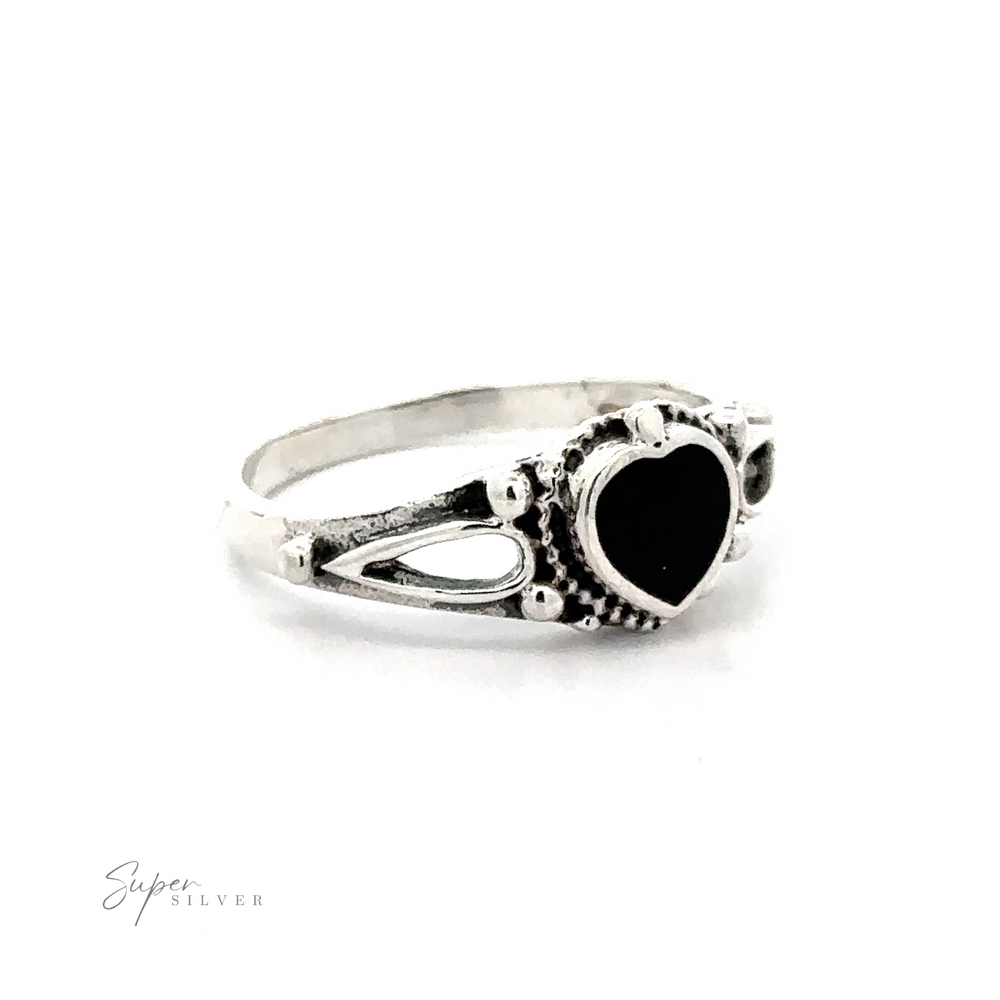 
                  
                    Inlaid Stone Heart Ring featuring a black heart-shaped inlaid stone with filigree details.
                  
                