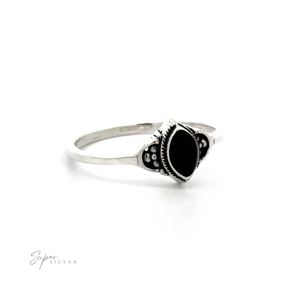 
                  
                    A Delicate Marquise Inlaid Stone ring with black stones on a white background.
                  
                