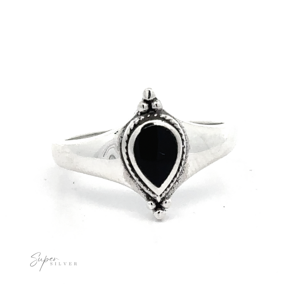 
                  
                    Teardrop Inlay Shield Ring with an oval black stone centerpiece and ornate detailing.
                  
                
