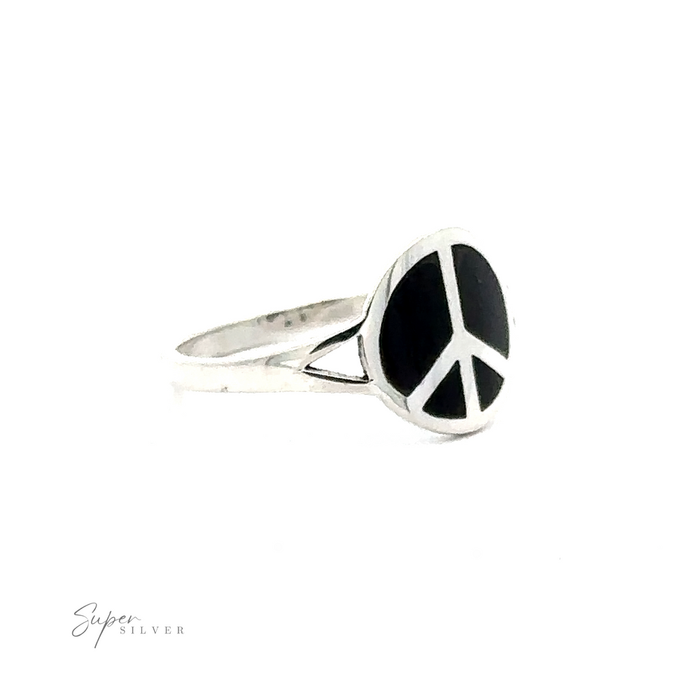 
                  
                    A silver ring featuring a black onyx oval face with a peace symbol design. The Stone Inlay Peace Sign Ring brand name "Super Silver" is visible in the bottom left corner.
                  
                
