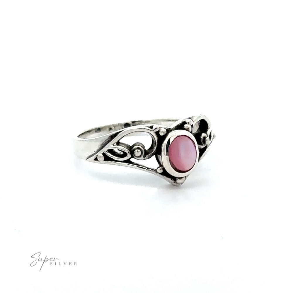 
                  
                    This Filigree Crown Ring with Inlaid Oval Stone has a vintage vibe, featuring a silver band adorned with intricate filigree details. Its elegant design is further enhanced by the addition of a beautiful pink.
                  
                