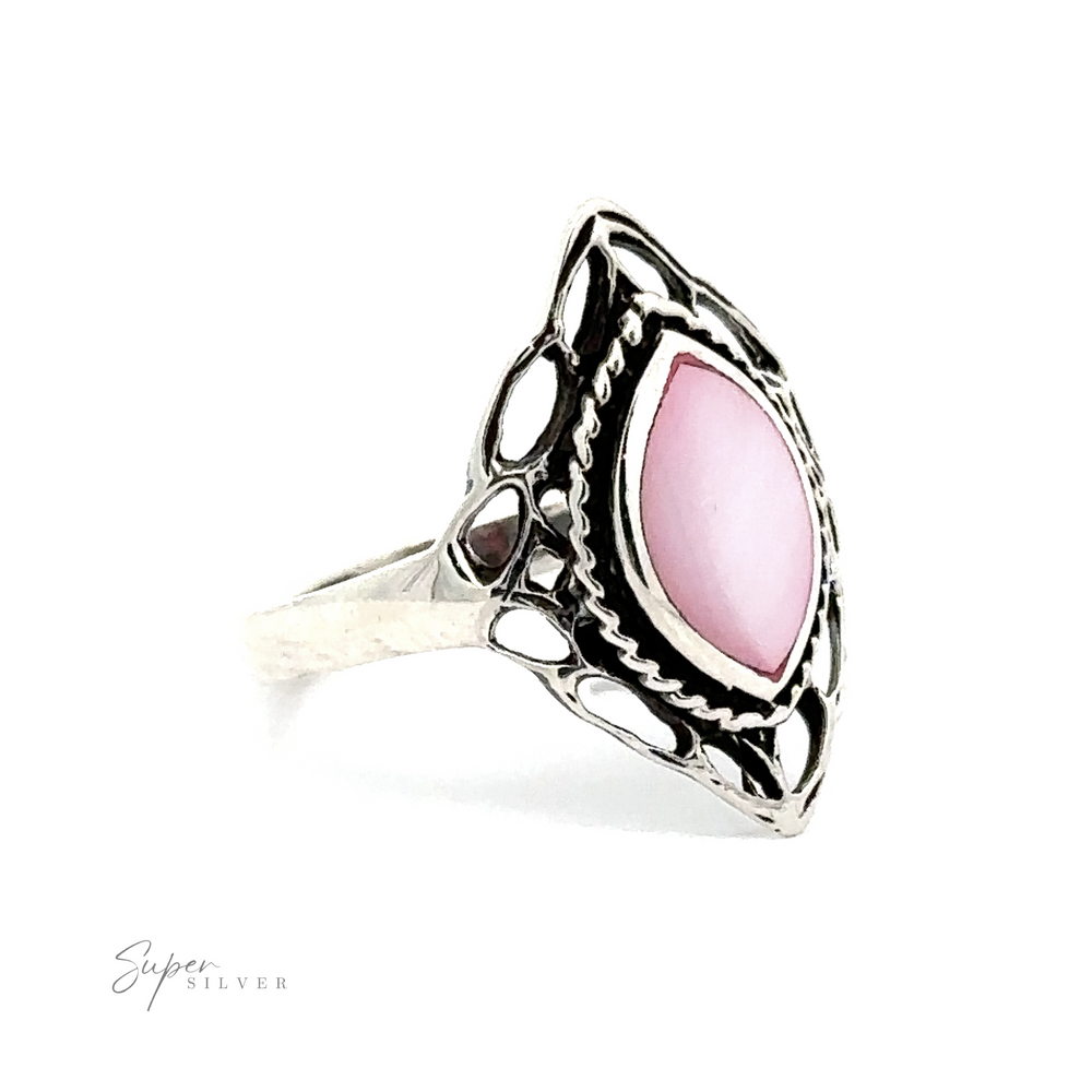 
                  
                    A Delicate Marquise Shield Ring with Inlaid Stones with a pink stone.
                  
                