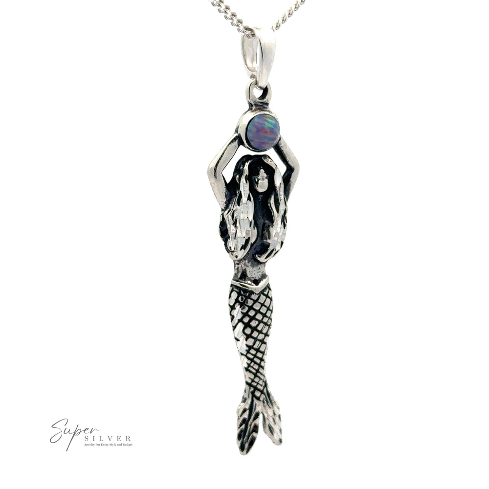
                  
                    A Mermaid And Opal Pendant is attached to an oxidized silver chain. The text "Super Silver" is in the lower left corner.
                  
                