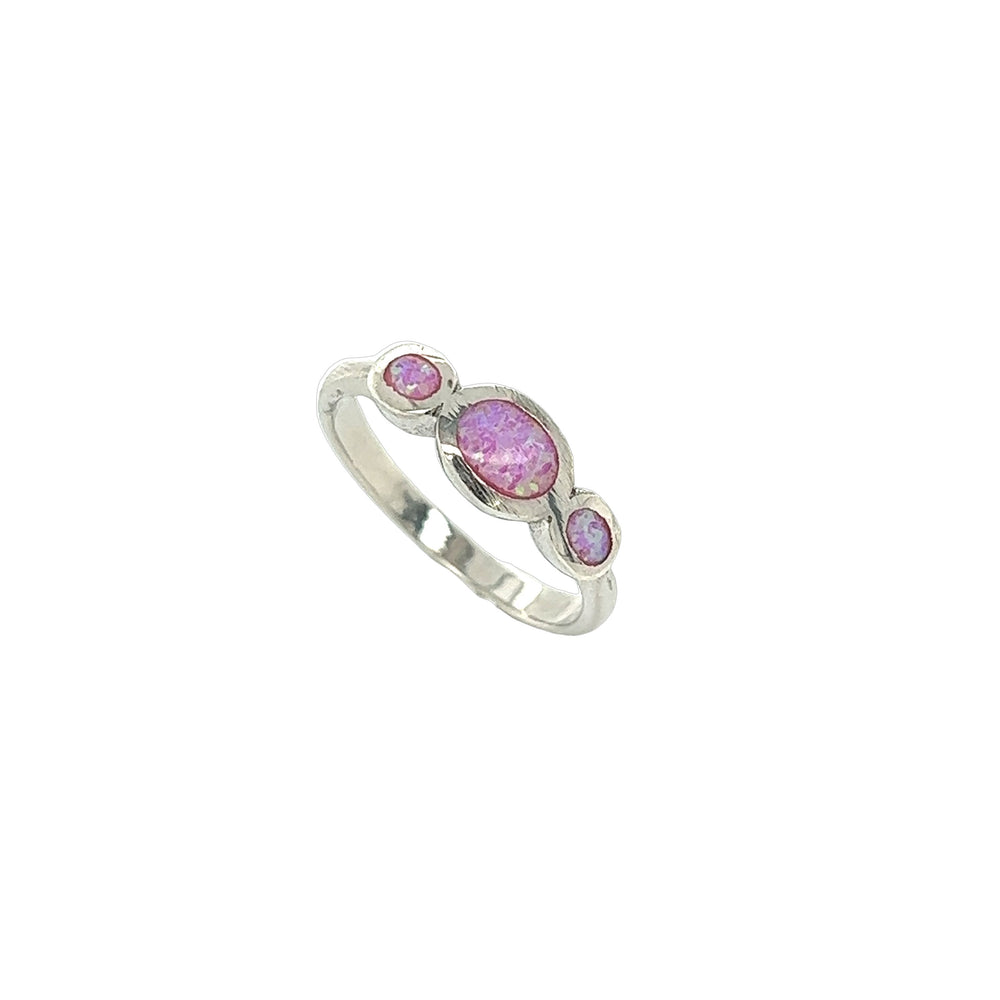 An elegant Triple Oval Opal Ring from Super Silver, with a rhodium finish, showcasing three pink stones on a white background.