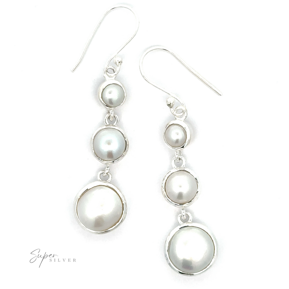 Elegant earrings featuring three round, graduated white pearls set in sterling silver. "Graduating Pearl Earrings" text is visible in the bottom left corner.