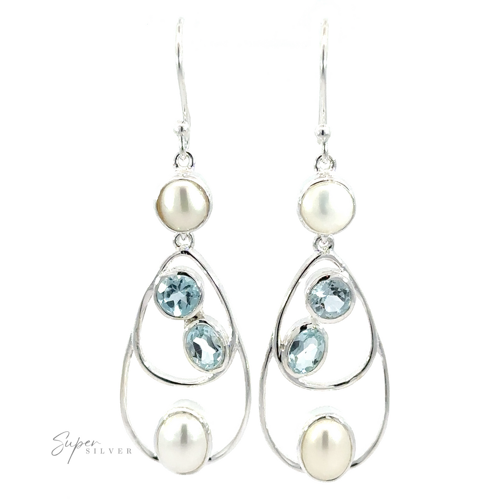 A pair of Stunning Teardrop Pearl and Blue Topaz Earrings featuring round and oval blue gemstones and pearls, with a hook fastening.