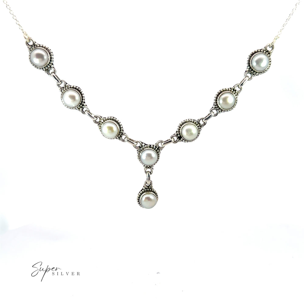 
                  
                    A Round Gemstone Y Necklace with Ball Border featuring a symmetrical arrangement of round pearls set in decorative settings, with a single pearl pendant hanging in the center. This exquisite piece adds a touch of bohemian style to any outfit, seamlessly blending elegance with laid-back charm.
                  
                