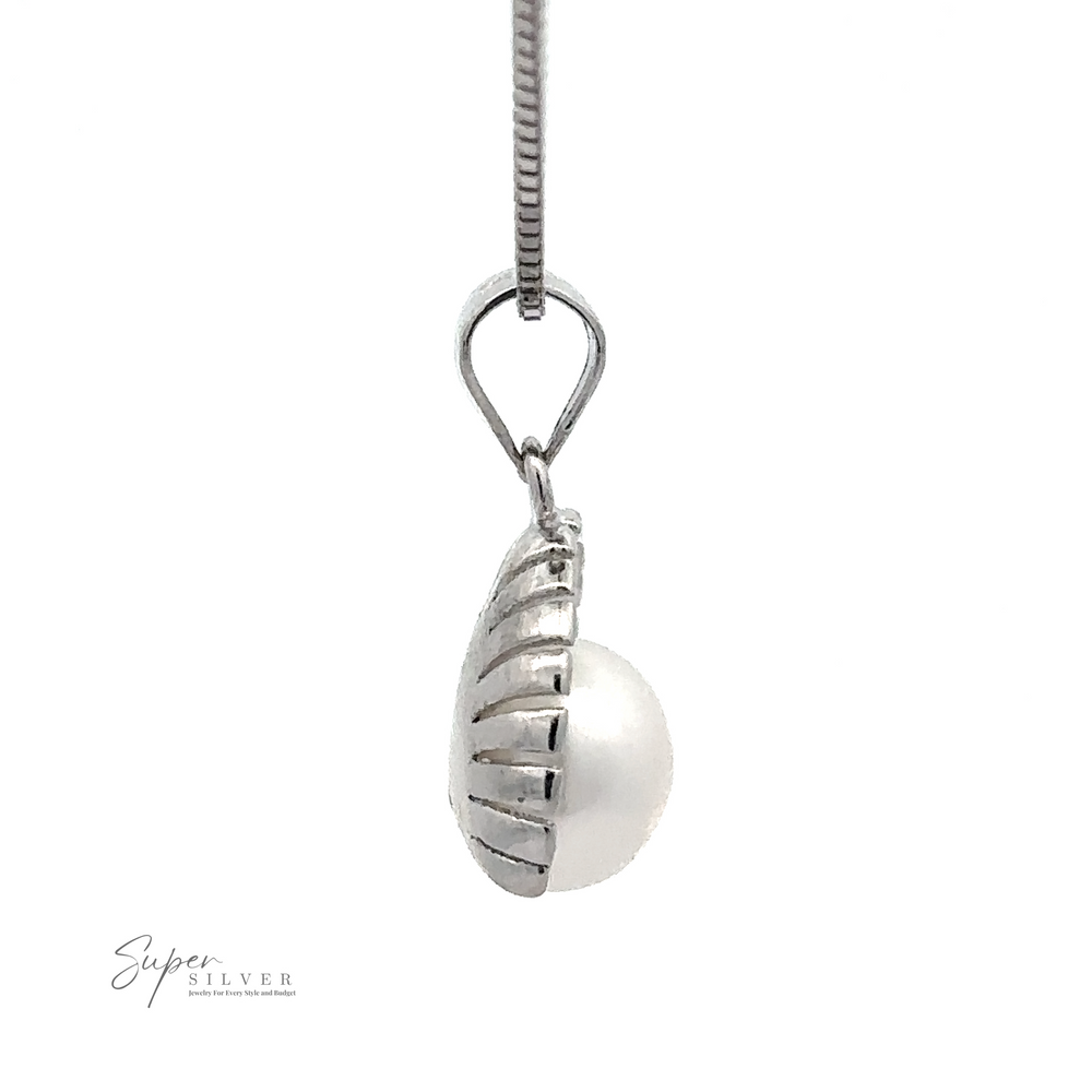 
                  
                    A Pearl Pendant with Shell Background with a Sterling Silver petite half shell design on the top, hanging from a silver chain. The logo "Super Silver" is visible in the bottom-left corner.
                  
                