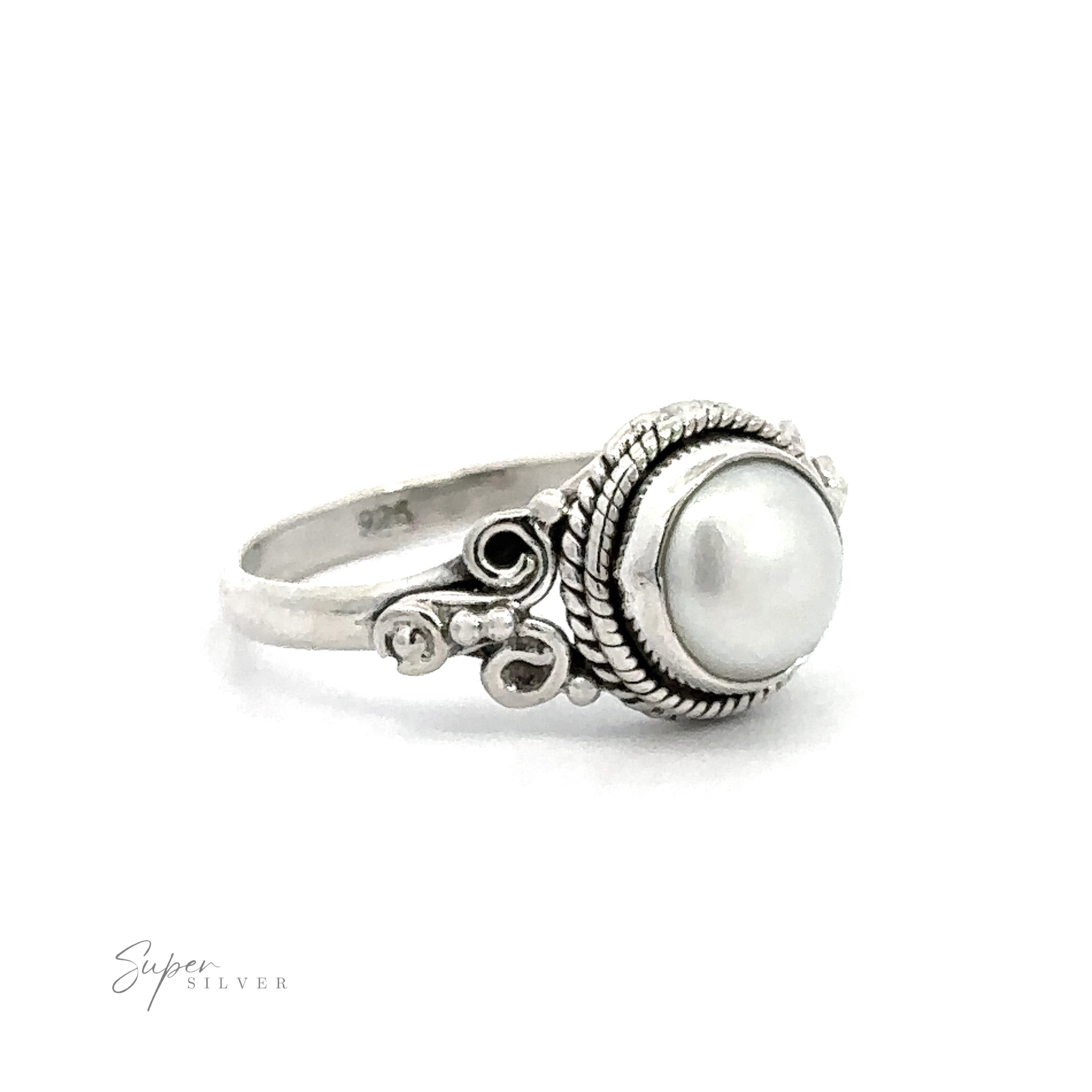 A vintage boho Natural Oval Gemstone Ring with intricate metalwork on a white background.