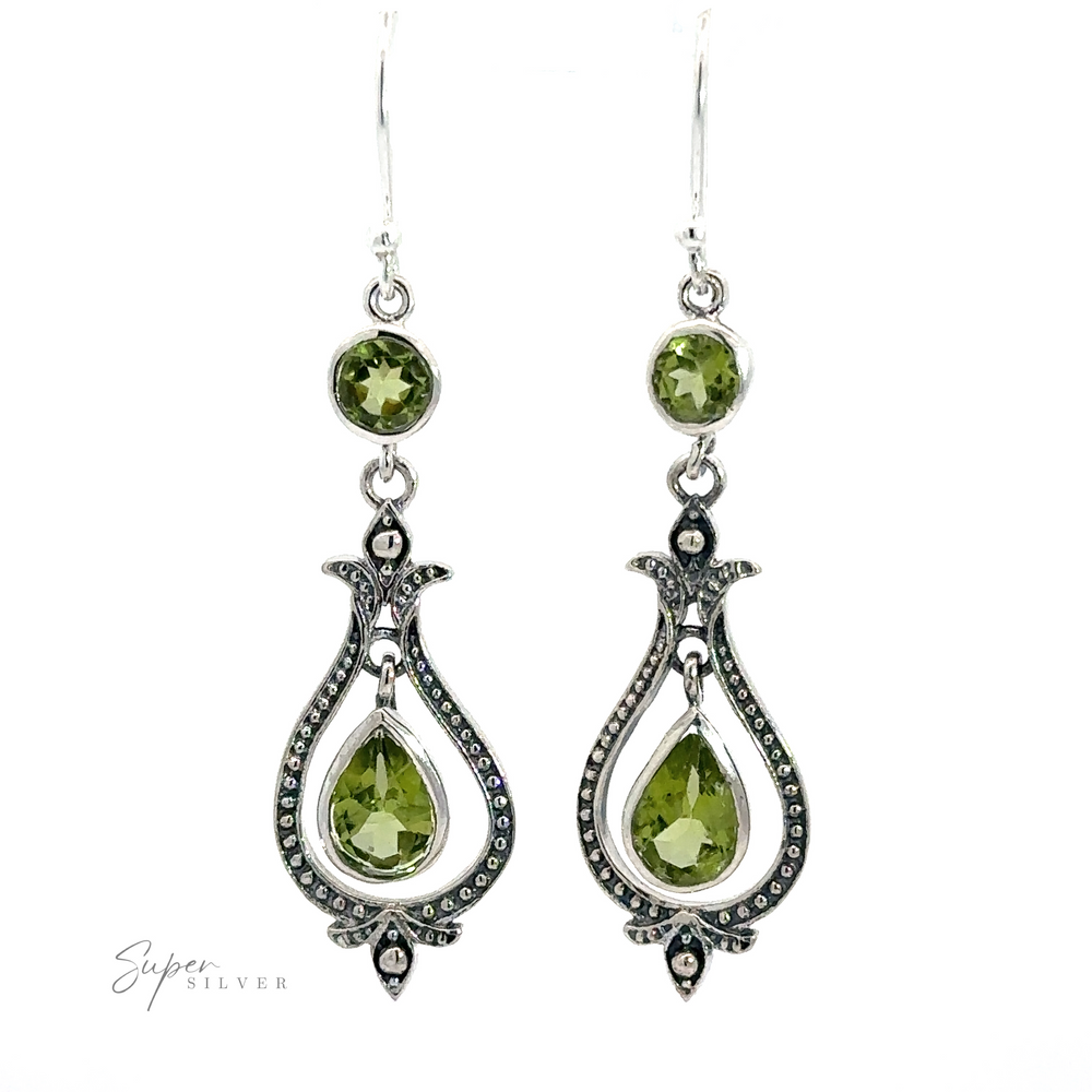 
                  
                    A pair of ornate Vintage-Styled Teardrop Earrings with Gemstones made from .925 sterling silver, featuring green gemstone accents and intricate detailing. The design includes small circular and vintage-style teardrop-shaped gems with a decorative metal framework.
                  
                