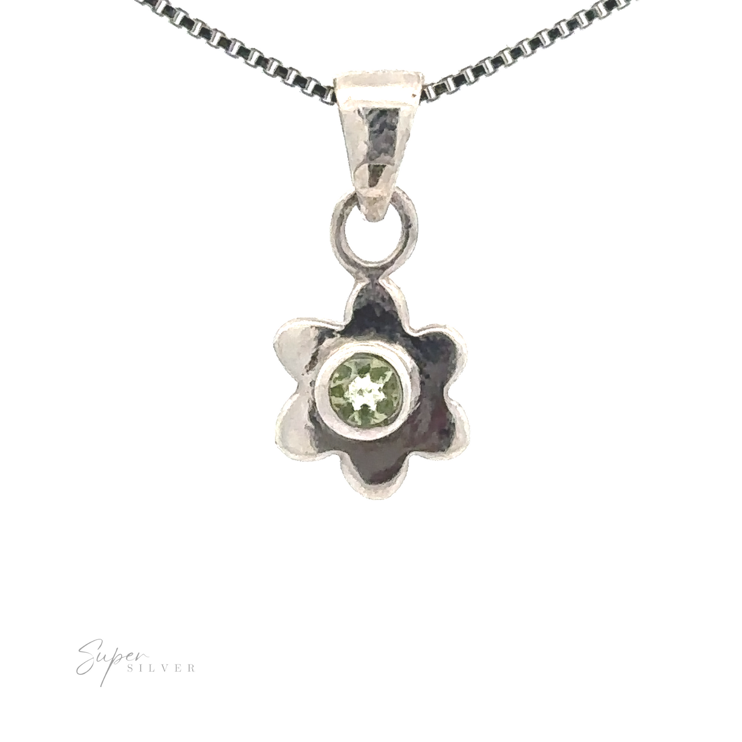 
                  
                    A Tiny Gemstone Flower Pendant with a green gemstone at its heart, showcasing a delicate flower design, hangs elegantly from a silver chain necklace.
                  
                