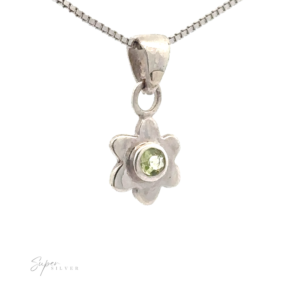 
                  
                    A sterling silver jewelry piece, this delicate Tiny Gemstone Flower Pendant features a small green gemstone at its center, artfully displayed against a white background.
                  
                