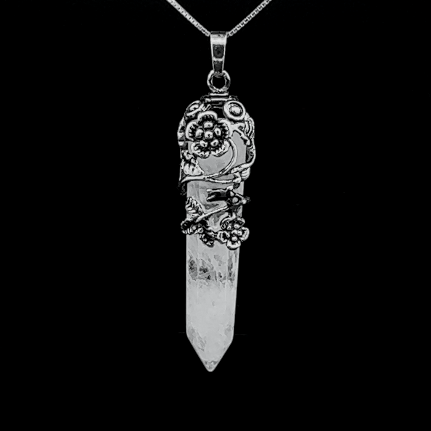 
                  
                    A Silver-Plated Flower Design Stone Pendant suspended from a silver-plated flower chain against a black background.
                  
                