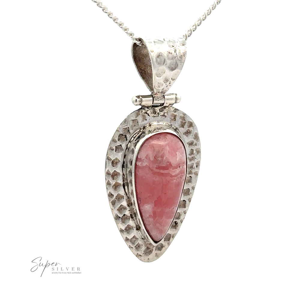 
                  
                    A Rhodochrosite Hammered Teardrop Pendant featuring a textured, teardrop-shaped frame with a Rhodochrosite gemstone in the center, known for its emotional healing properties. The unique design is completed by the pendant hanging from an elegant silver chain.
                  
                