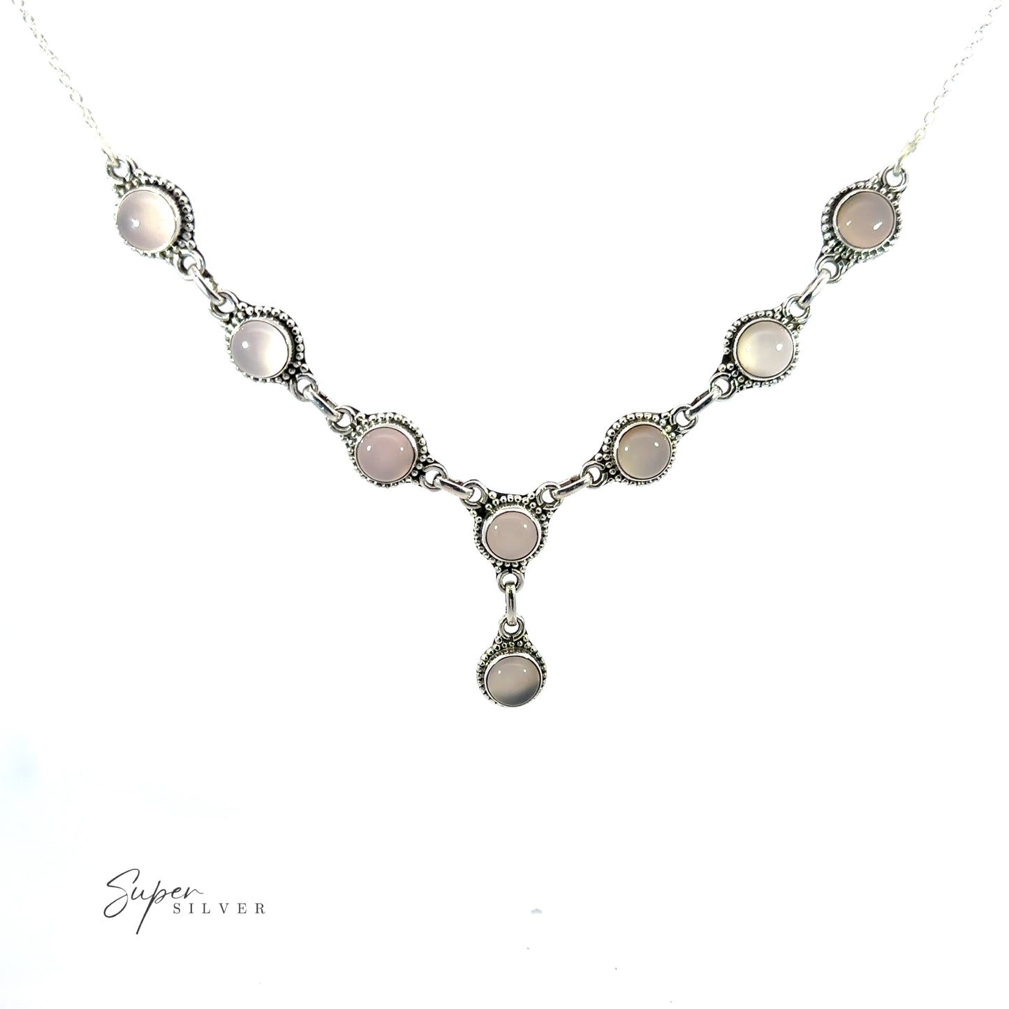 
                  
                    A Round Gemstone Y Necklace with Ball Border with eight round, light-colored stones in a linked pattern. This bohemian style jewelry piece features a single dangling stone at the center, and the text "Super Silver" is visible in the lower-left corner.
                  
                