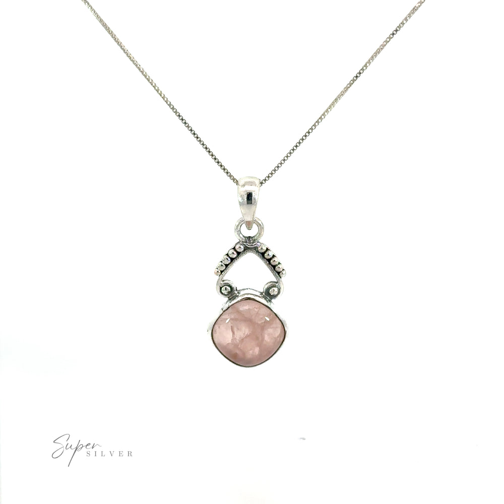 
                  
                    A bohemian-inspired diamond shaped gemstone pendant on a silver chain, adorned with gemstones.
                  
                