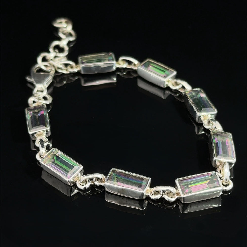 A Rectangle Rainbow Mystic Topaz Bracelet featuring rectangular, iridescent gemstones linked together beautifully, displayed on a sleek black background.