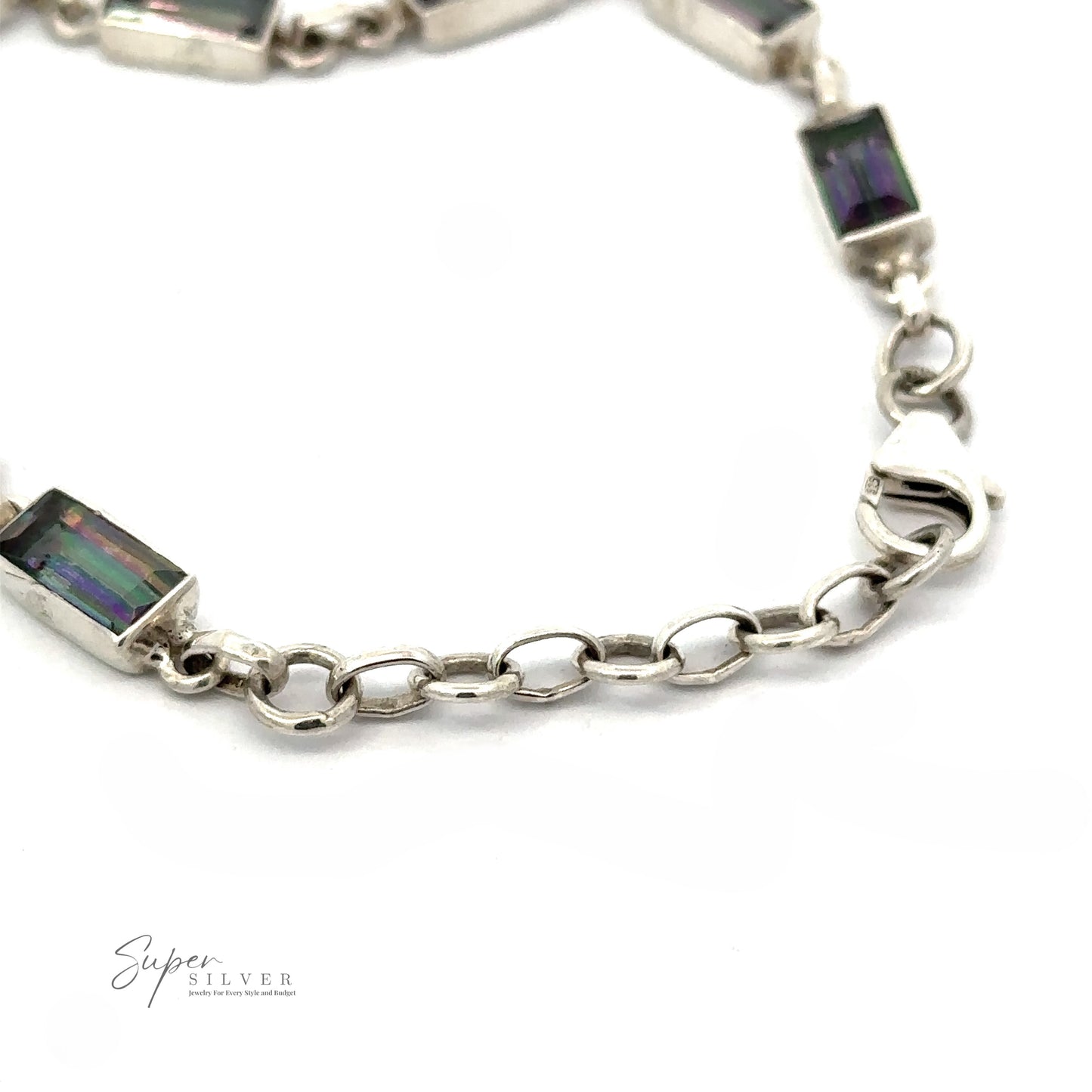 
                  
                    Close-up of a sterling silver bracelet featuring rectangular multi-colored gemstone links. The clasp and part of the chain are visible. The text "Rectangle Rainbow Mystic Topaz Bracelet" is imprinted in the lower left corner.
                  
                