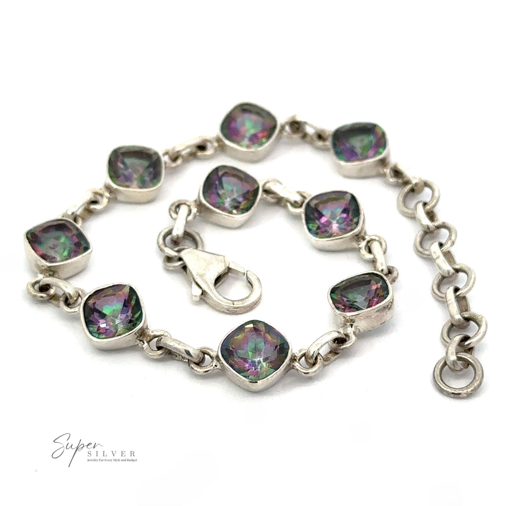 
                  
                    A Rainbow Mystic Topaz Diamond Link Bracelet featuring purple and green gem-like stones in square settings with a lobster clasp and an adjustable chain.
                  
                