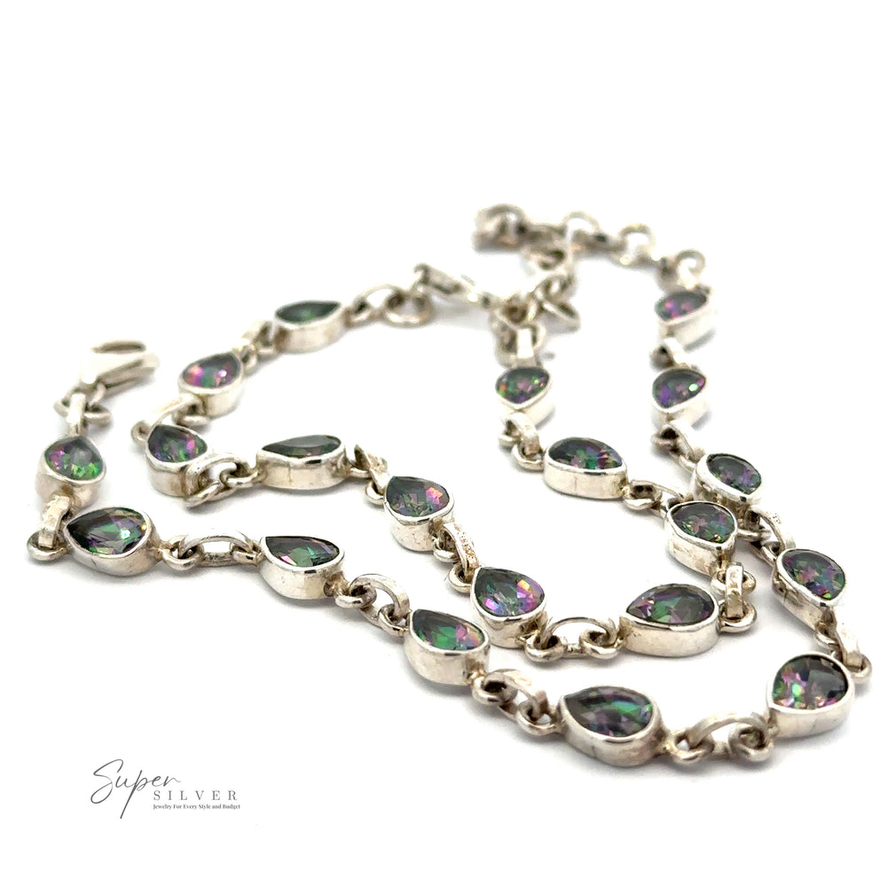 Silver necklace with teardrop-shaped, iridescent gemstones. 