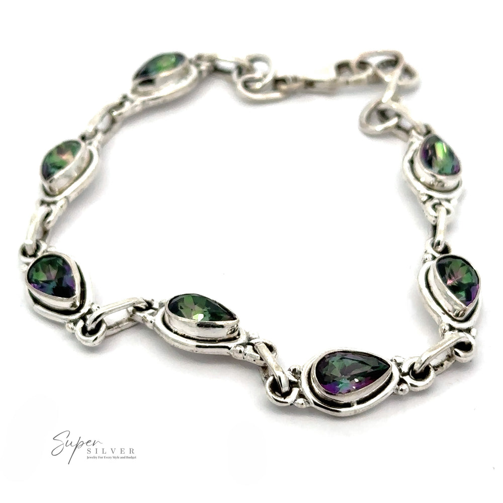 
                  
                    A Rainbow Topaz Bordered Teardrop Bracelet with green and purple gem accents, featuring a secure clasp and brand logo "Super Silver" in the corner.
                  
                