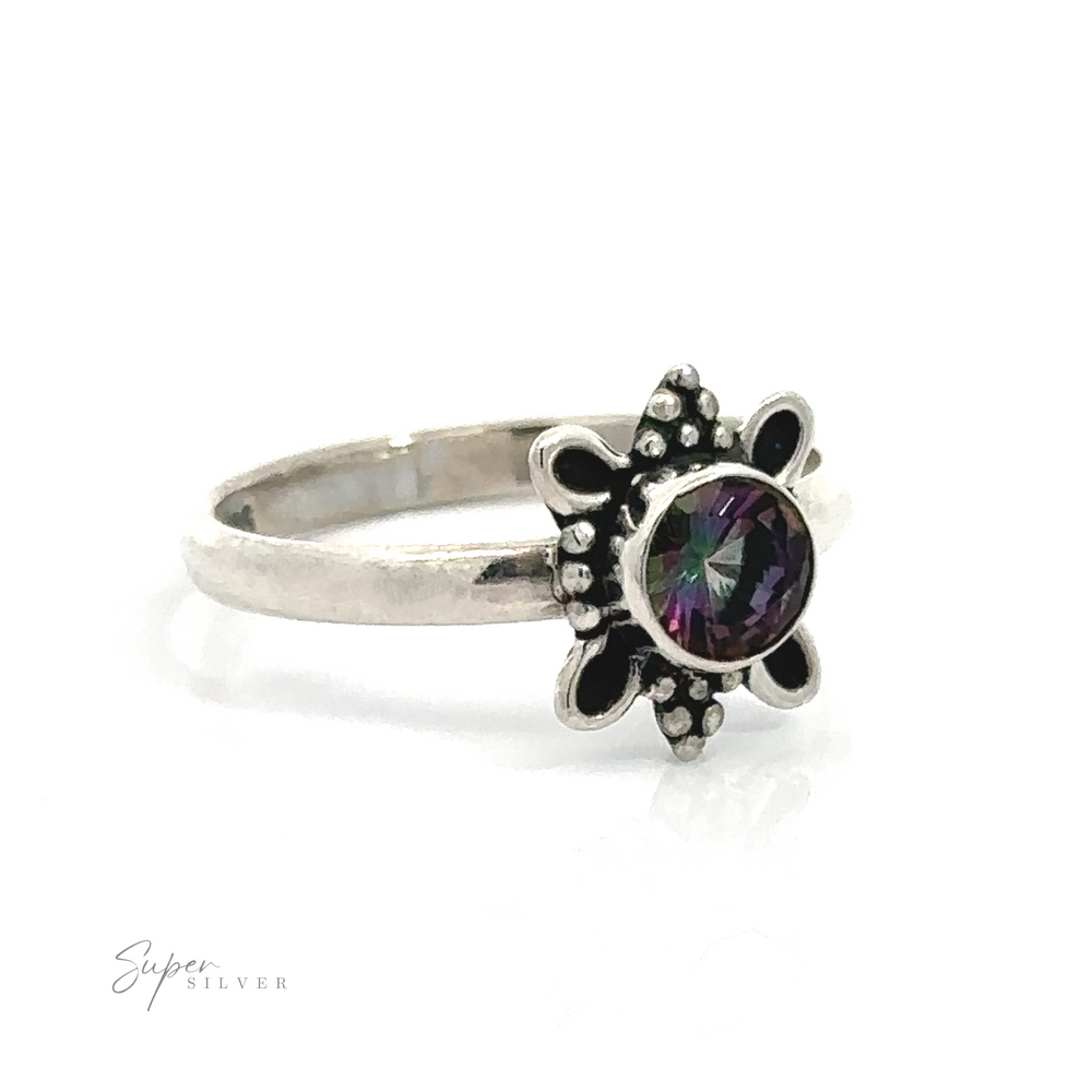 
                  
                    Round Faceted Gemstone Ring with Ball and Loop Design with a central gemstone surrounded by a nature-inspired floral design.
                  
                