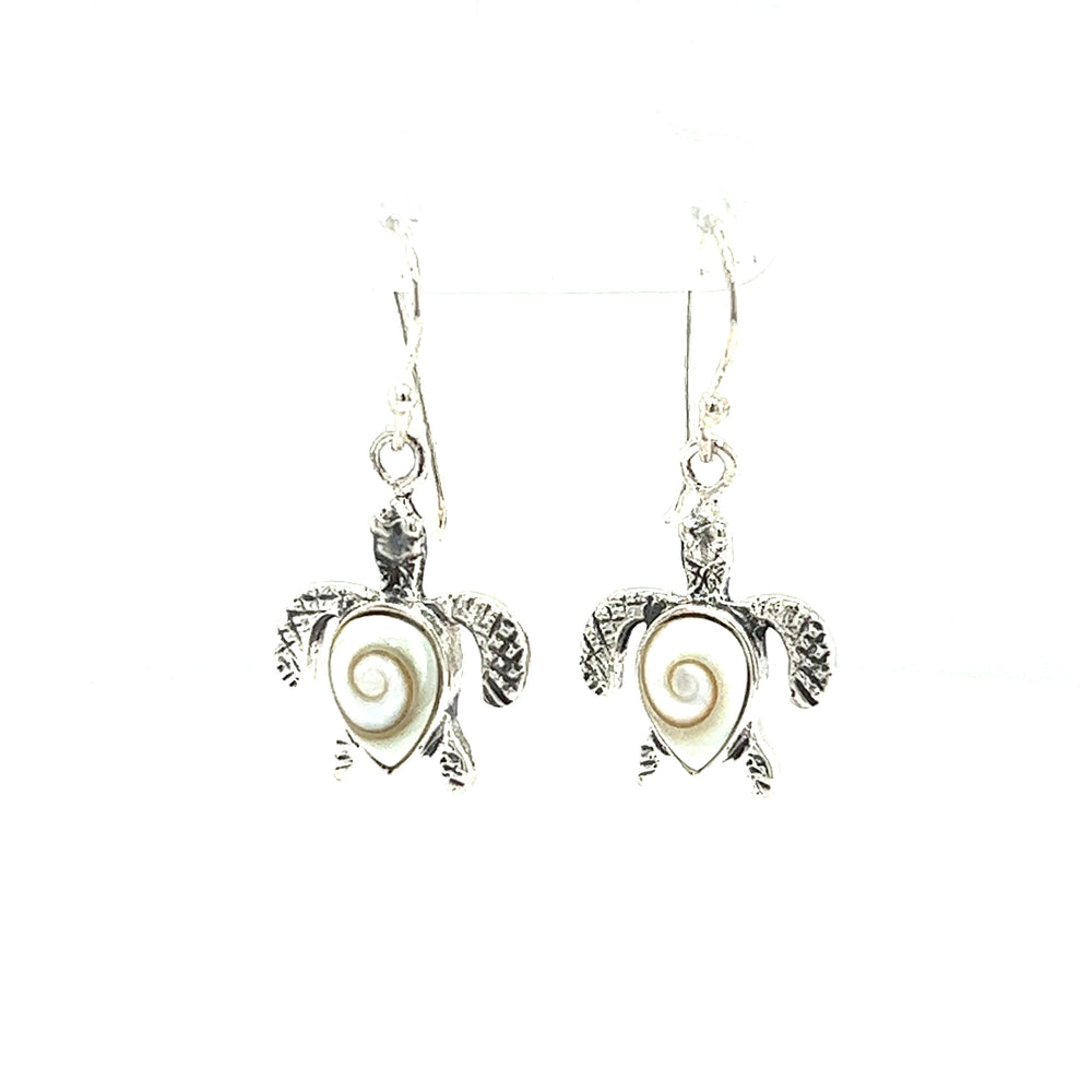 A pair of Super Silver Sea Turtle Earrings with Shiva Shell shells shimmering on them.