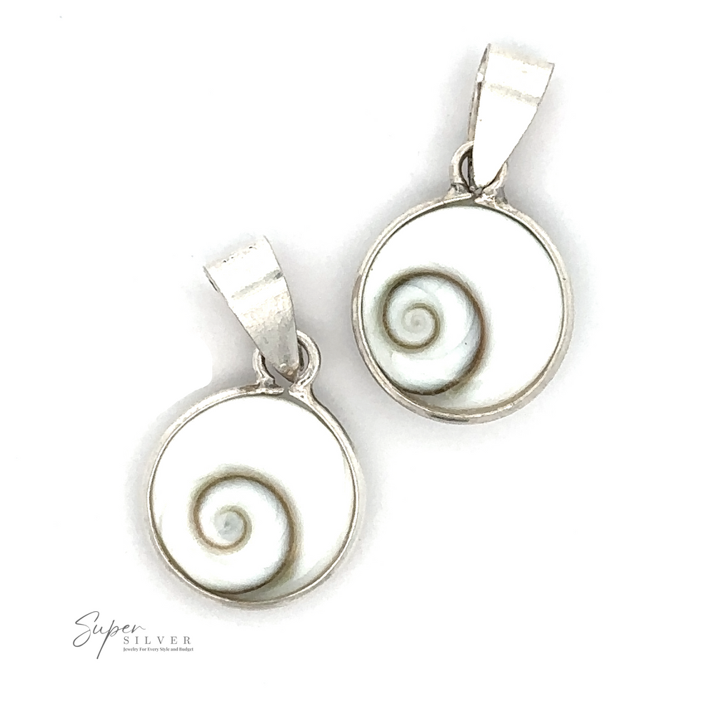 Two round, silver pendants featuring white shells with a green spiral pattern in the center exude coastal elegance. These Small Round Shiva Shell Pendants have loop bails at the top for attaching to a chain. Text reads 