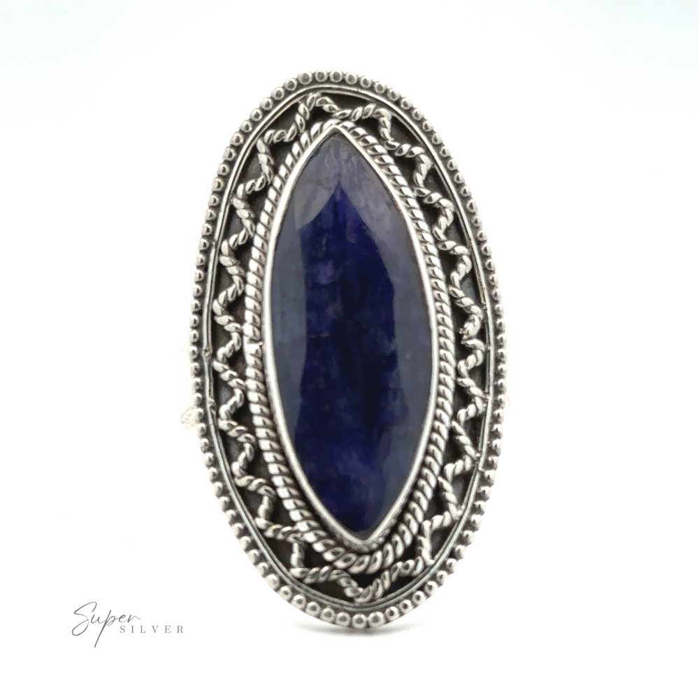 
                  
                    An elongated oval-shaped blue gemstone set in an intricately designed sterling silver ring. The band features an ornate pattern of rope and bead details, adding a Bohemian twist. "Marquise Shaped Gemstone Ring With Vintage Shield Border" is inscribed in the lower left corner.


                  
                