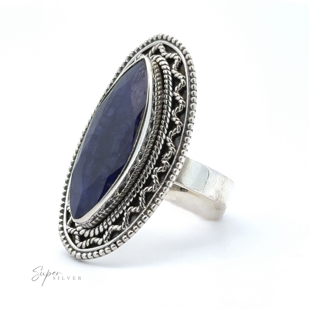 
                  
                    A Marquise Shaped Gemstone Ring With Vintage Shield Border with an oval-shaped, deep blue stone set in an intricate, decorative band. The brand name "Super Silver" is seen in the bottom left corner. This sterling silver piece adds a subtle Bohemian twist to any outfit.
                  
                