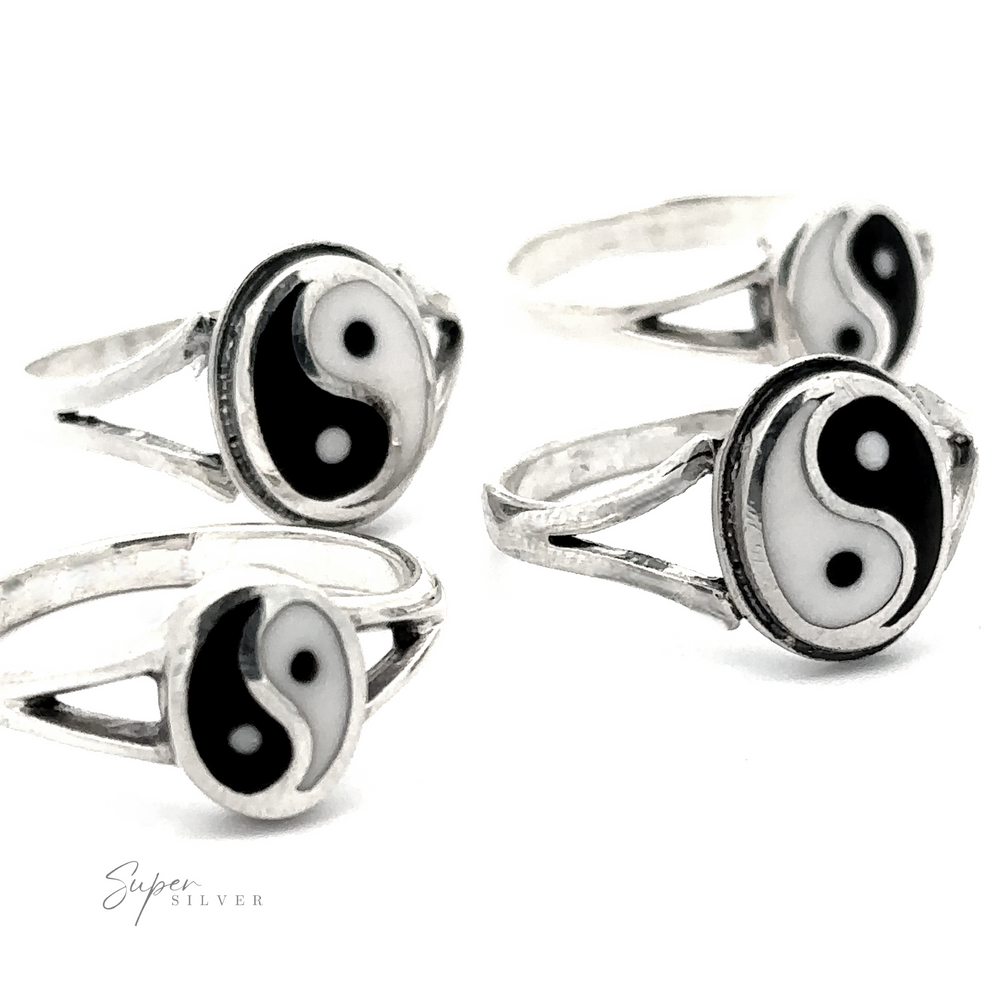 Sterling Silver rings, known as the Simple Inlaid Yin-Yang Rings, feature black and white yin-yang symbols set against white backgrounds and are displayed in pairs. These minimalist pieces of jewelry are perfect for achieving a balanced and elegant look.