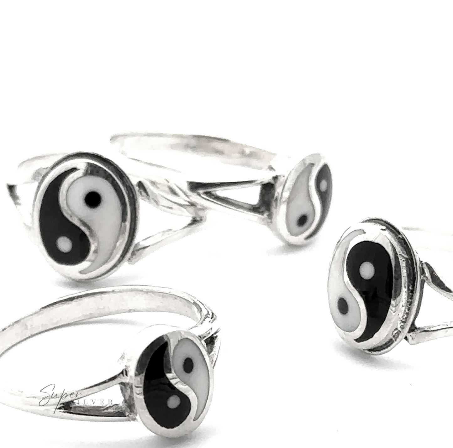 
                  
                    Four Simple Inlaid Yin-Yang Rings, crafted from sterling silver and featuring black and white yin-yang symbols, are artfully scattered on a white background, showcasing minimalist jewelry at its finest.
                  
                